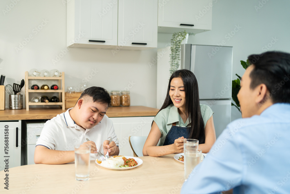 Asian happy family, mature parent having breakfast with son in kitchen. Asian happy family, mature parent having breakfast with son in kitchen.