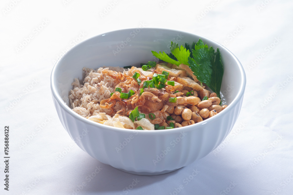 Bubur Ayam Sukabumi contains white rice porridge with side dishes of fried chicken slices Bubur Ayam Sukabumi contains white rice porridge with side dishes of fried chicken slices