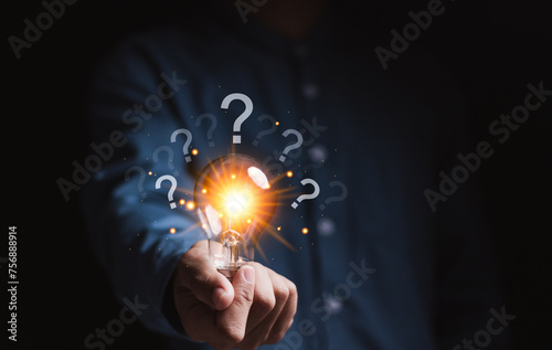 Question mark concept. Problem and solution. Quiz, test, survey, support, knowledge, decision. Businessman holding light bulb with question mark icon for FAQ.