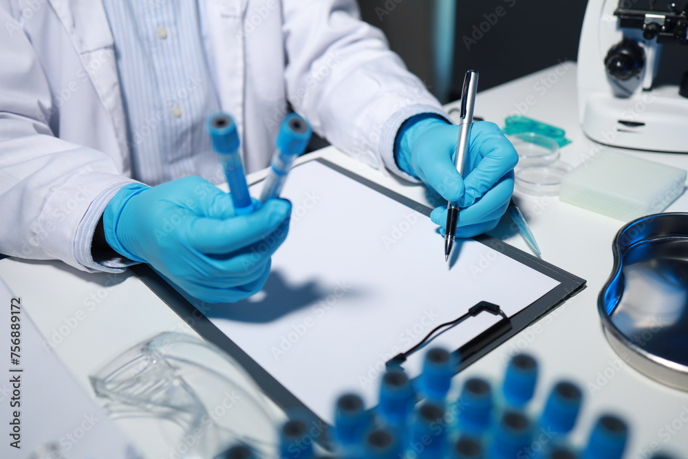A researcher is taking notes. It is being developed in the lab as a profile for other researchers, A biological chemical scientist is writing a report on his day's work for a boss. A researcher is taking notes. It is being developed in the lab as a profile for other researchers, A biological chemical scientist is writing a report on his day's work for a boss.