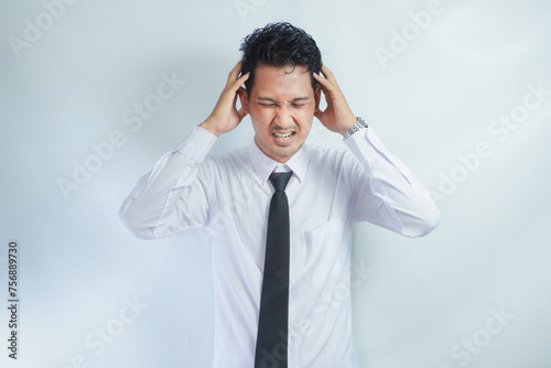 Adult Asian man got painful headache gesture photo