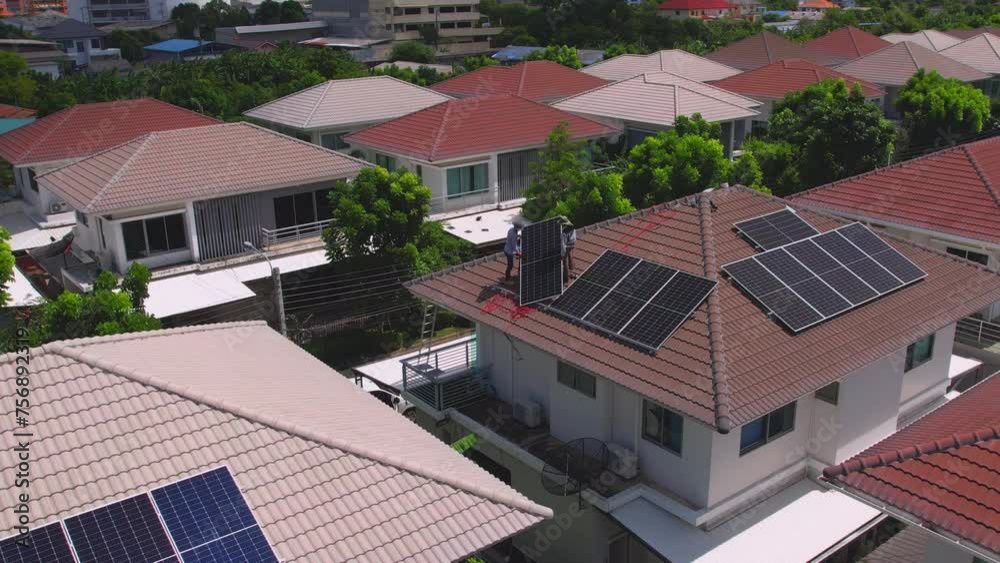 Drone view of engineer worker installed solar panels on roof of house. 