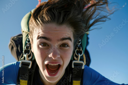 Close-up of a lovely young woman gracefully freefalling before deploying her parachute © Veniamin Kraskov