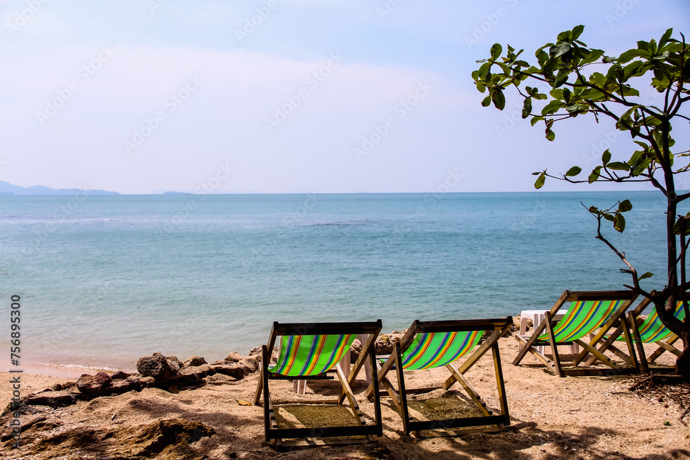 Landscape sea view with colorful beach chair on sand beach background