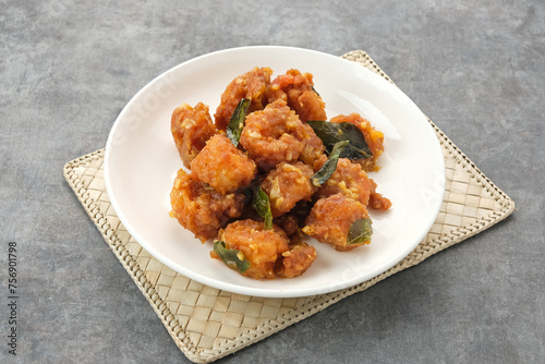 Salted egg fried shrimp or udang telur asin with curry leaves
 photo