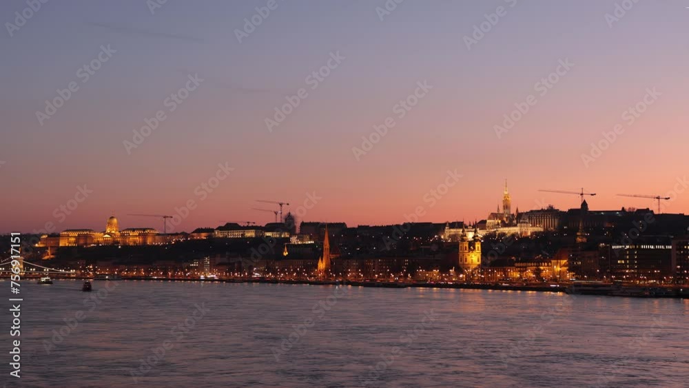 Twilight timelapse of Daube River, Buda Castle and illuminated Budapest skyline Twilight timelapse of Daube River, Buda Castle and illuminated Budapest skyline