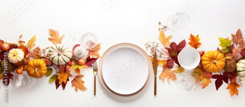 A creative arts table setting for Thanksgiving with pumpkins, leaves, and a plate. Incorporating flowers, twigs, and jewelry. A beautiful display inspired by nature and art photo