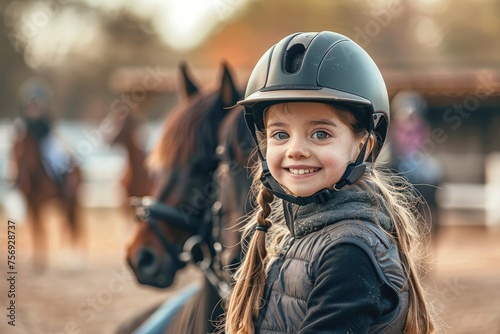Happy young girl at horse riding lesson looking at camera while wearing equestrian helmet © kardaska