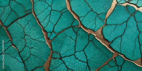 Cracked teal patterns of verdigris on a bronze surface. Hint of kintsugi art photo