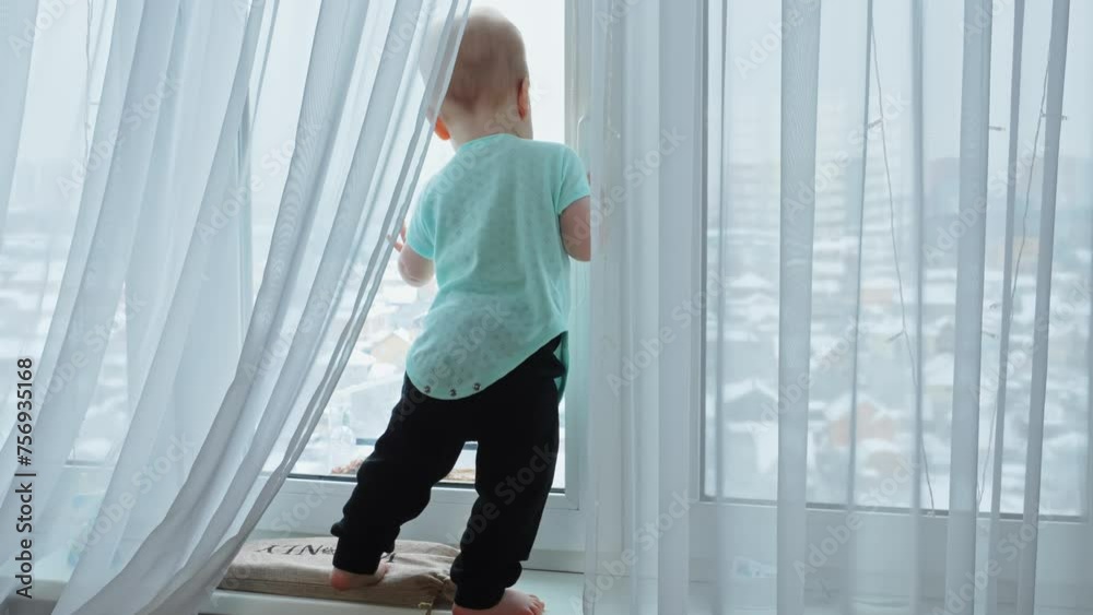 A little boy plays on the windowsill, gazing out the window. A moment of innocent joy and childhood wonder. A little boy plays on the windowsill, gazing out the window. A moment of innocent joy and childhood wonder.