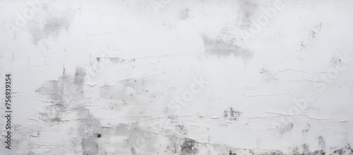 A closeup of a white wall covered in various stains, resembling a snowy landscape with a monochrome color scheme reminiscent of winter and freezing temperatures © TheWaterMeloonProjec