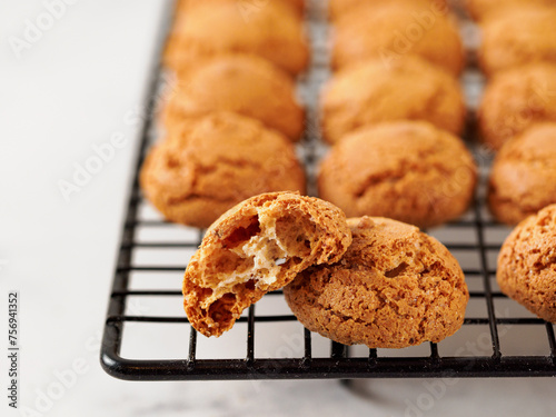 Amaretti cookie on cooling rack - traditional Italian Sardinian pastry. Delicious amaretti biscuit cookies made from almond or apricot kernels with copy space