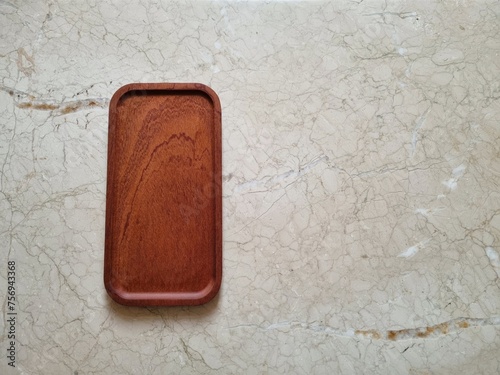 Wooden tray on granite surface