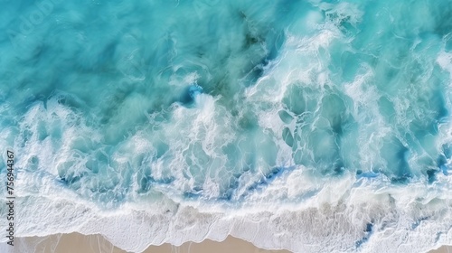 Aerial view capturing the turquoise hues of ocean water, with splashes and foam creating a captivating natural abstract texture.