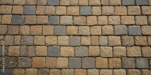 Paving stone pavement texture. Cobblestone pavement top view. Old stone sidewalk. Paving texture