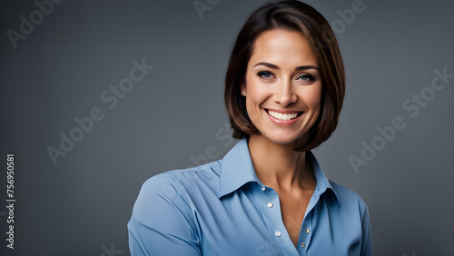 A confident female entrepreneur looking at the camera with a smile on a solid background
