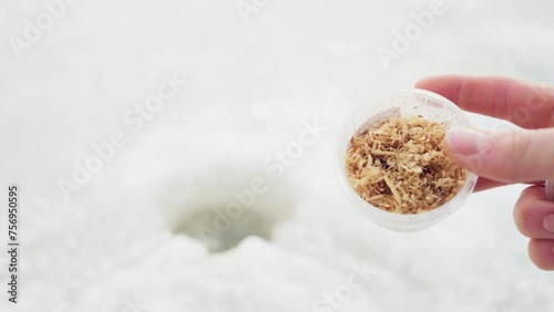 A Man's Hand Displays Bait for Ice Fishing in Bessaker, Trondelag County, Norway - Close Up photo