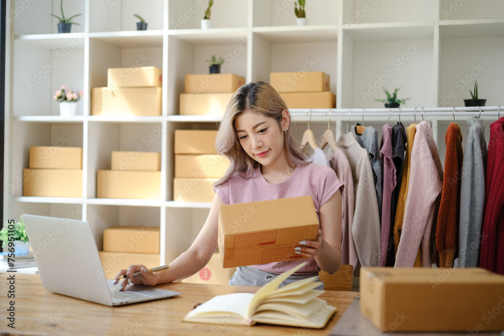 Online shopping concept, Female entrepreneur confirm order and writes address on parcel boxes. Online shopping concept, Female entrepreneur confirm order and writes address on parcel boxes.