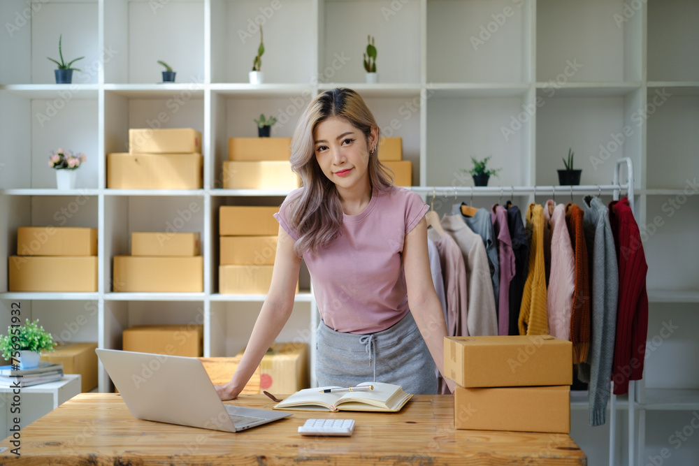 Portrait of young Asian woman SME working with a box at home the workplace.start-up small business owner, small business entrepreneur SME or freelance business online and delivery concept. Portrait of young Asian woman SME working with a box at home the workplace.start-up small business owner, small business entrepreneur SME or freelance business online and delivery concept.