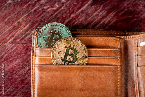 Bitcoins in a wallet on a wooden background