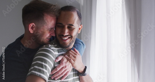 Diverse gay couple shares a tender moment, with