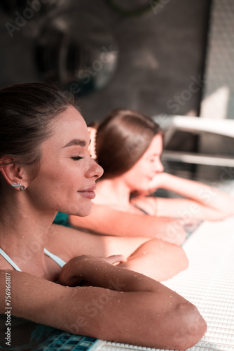 Two sexy women swim in the pool.Womans relaxes in the spa.Relaxation concept in the hotel