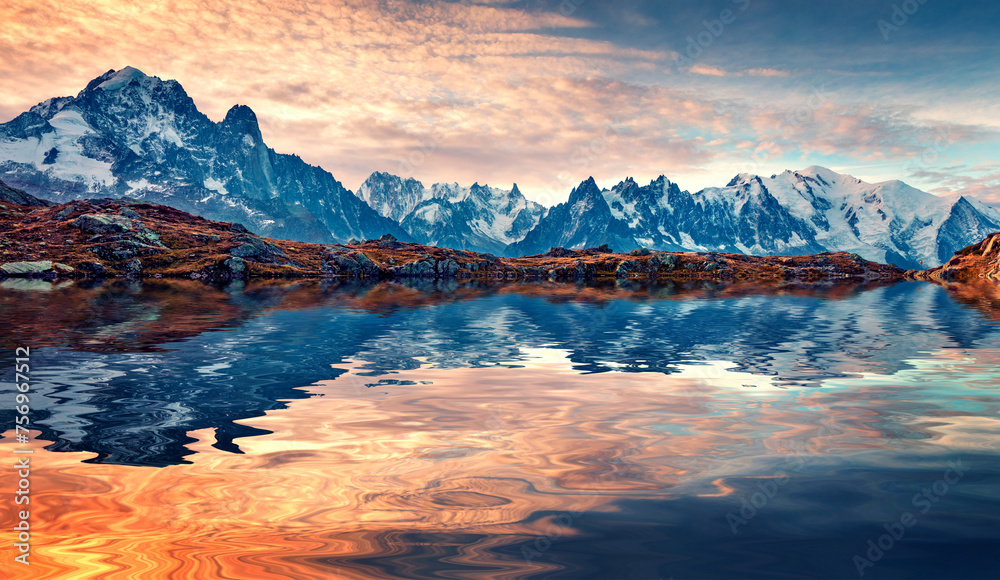 Snowy Mount Blank peak reflected in the calm waters of Cheserys lake. Autumn sunset in French Alps, Chamonix location. Beautiful outdoor scene of Vallon de Berard Nature Park, France, Europe.