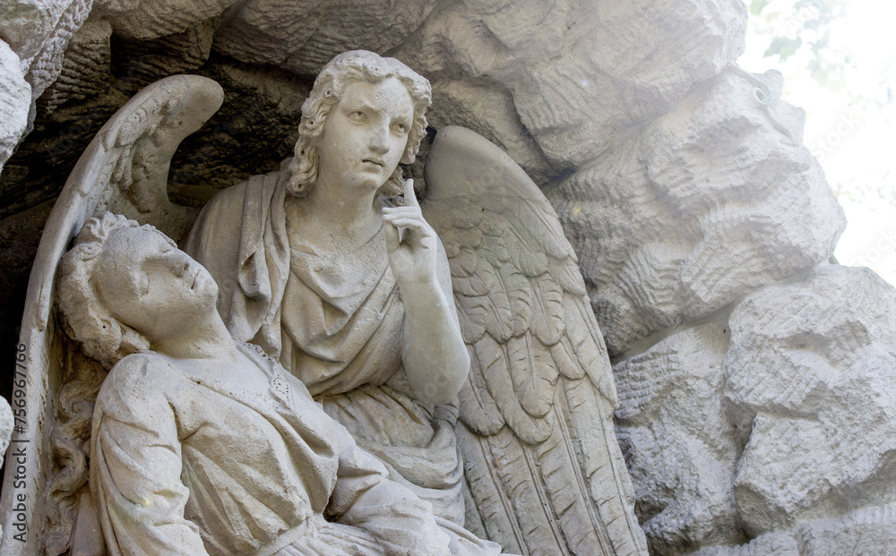 Fototapeta premium An angel with large wings is photographed from behind