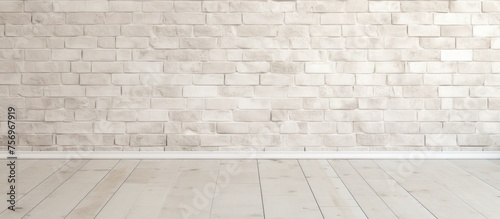 A rectangular room with beige brick walls and a hardwood flooring pattern in parallel lines. The wooden floor adds warmth to the space