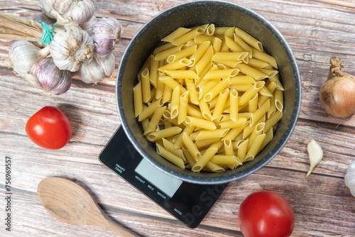 Preparing healthy and nutritious pasta. Weighing pasta on a kitchen scale, counting calories and checking macronutrients. Healthy Mediterranean diet