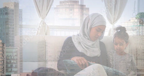 Image of asian mother in hijab at home with daughter over cityscape