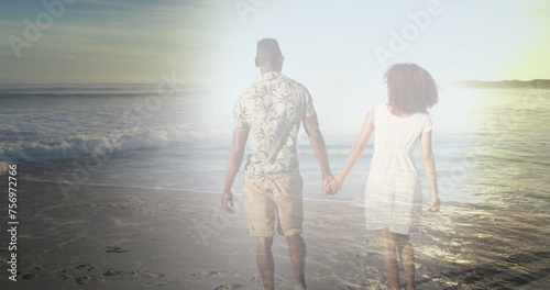 Image of african american couple holding hands at beach over sea #756972766