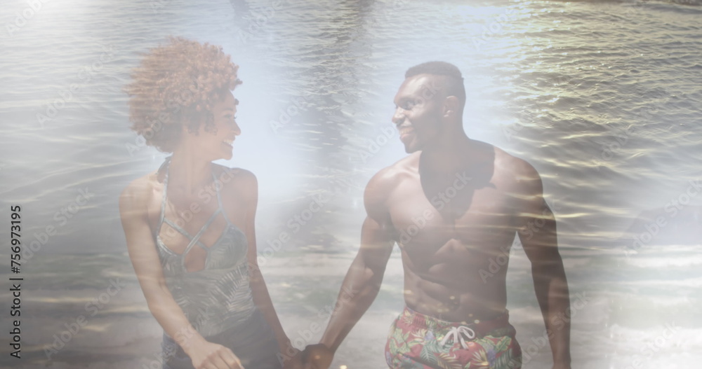 Naklejka premium Image of happy african american couple at beach over sea