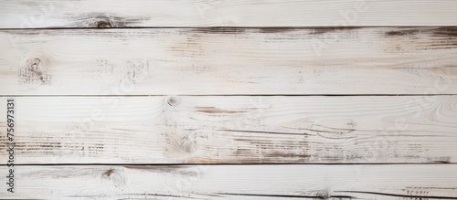 A closeup of a rectangular white hardwood table with a wood stain pattern on the surface. The blurred background highlights its parallel plank flooring made of composite material