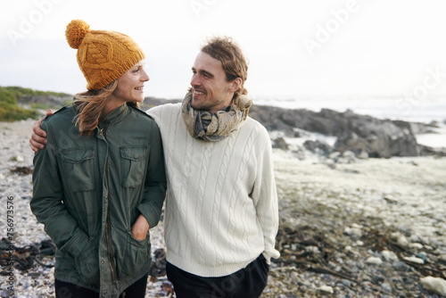 Walking  love and couple by ocean in winter for bonding  romantic relationship and relax outdoors. Marriage  travel and happy man and woman by sea for holiday  vacation and weekend together in nature