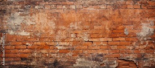 Textured old brick wall of a house in orange hue.