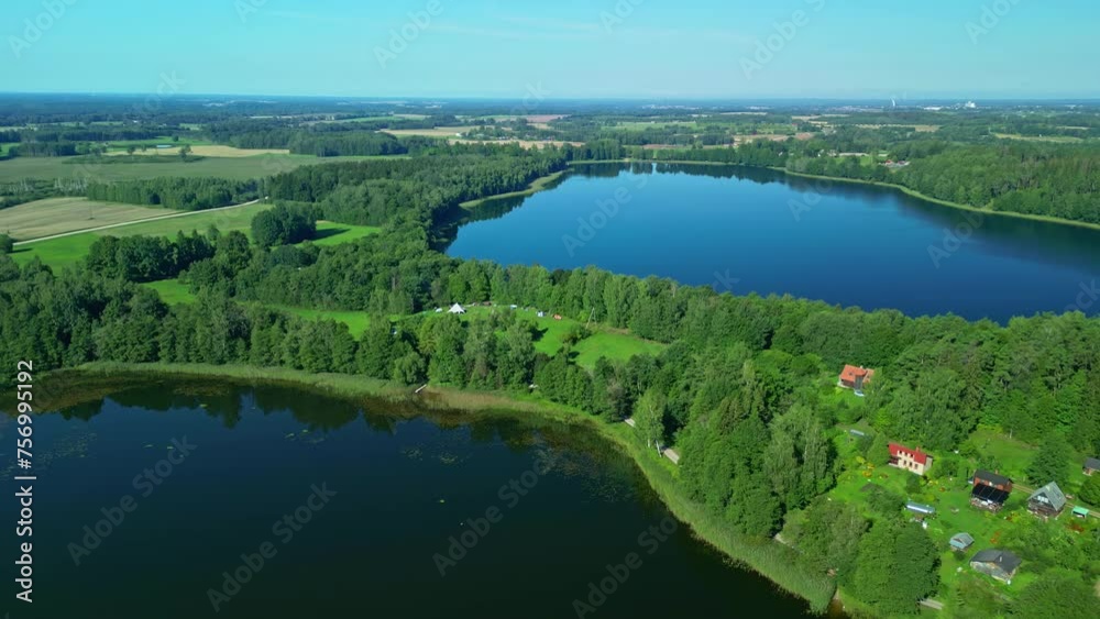 Scenic Aerial Drone Shot Over Lakes and Campsite in Latvia with Green Countryside Views