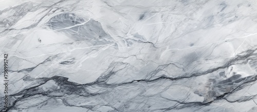 A closeup of a snowcovered white marble texture on a freezing winter landscape, showcasing the glacial landform and bedrock beneath the icy surface