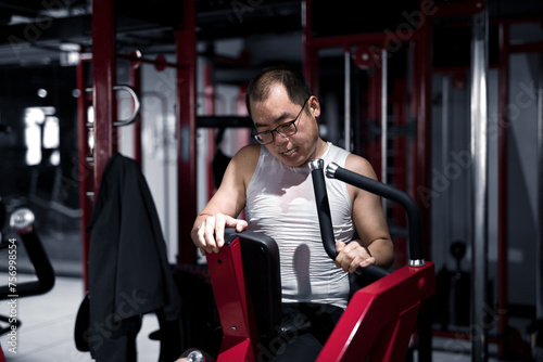 Men exercise their arm muscles in the gym