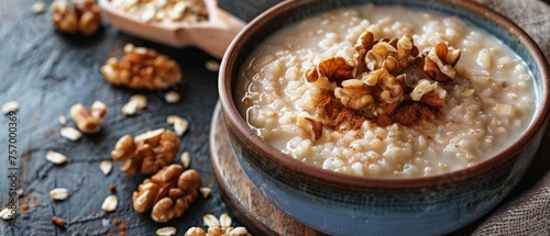 Rice porridge with dairy topped with walnuts on a background photo