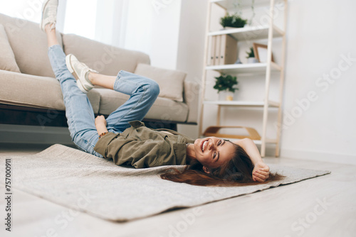 Cosy Home Relaxation: A Happy Woman Lying on a Modern Sofa in a Peaceful Apartment.
