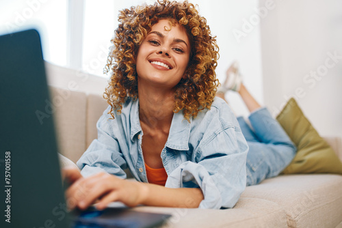 Smiling Woman Typing on Laptop in Cozy Home Office, Embracing the Modern Freelance Lifestyle