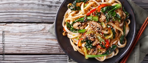 Top view of Asian vegetarian udon noodles with bok choy and shiitake mushrooms on a plate