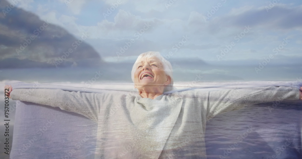 Fototapeta premium Close up of an old Caucasian woman happily stretching her arms wide