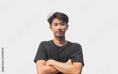 A young Asian man in his 20s wearing a black t-shirt stands confidently with his arms crossed over his chest, isolated on a gray background.