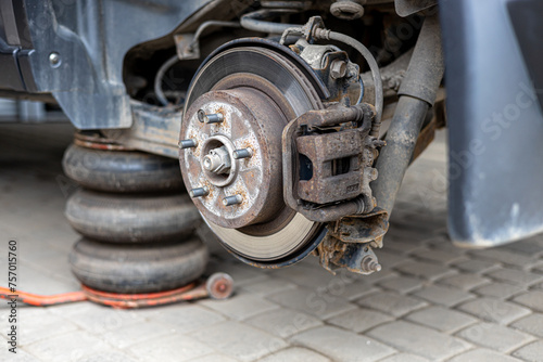 Tyre service. Compressed air tool. Changing the tyres on the car, car service.Auto mechanic,in process of new tire replacement, Car brake repairing in garage.