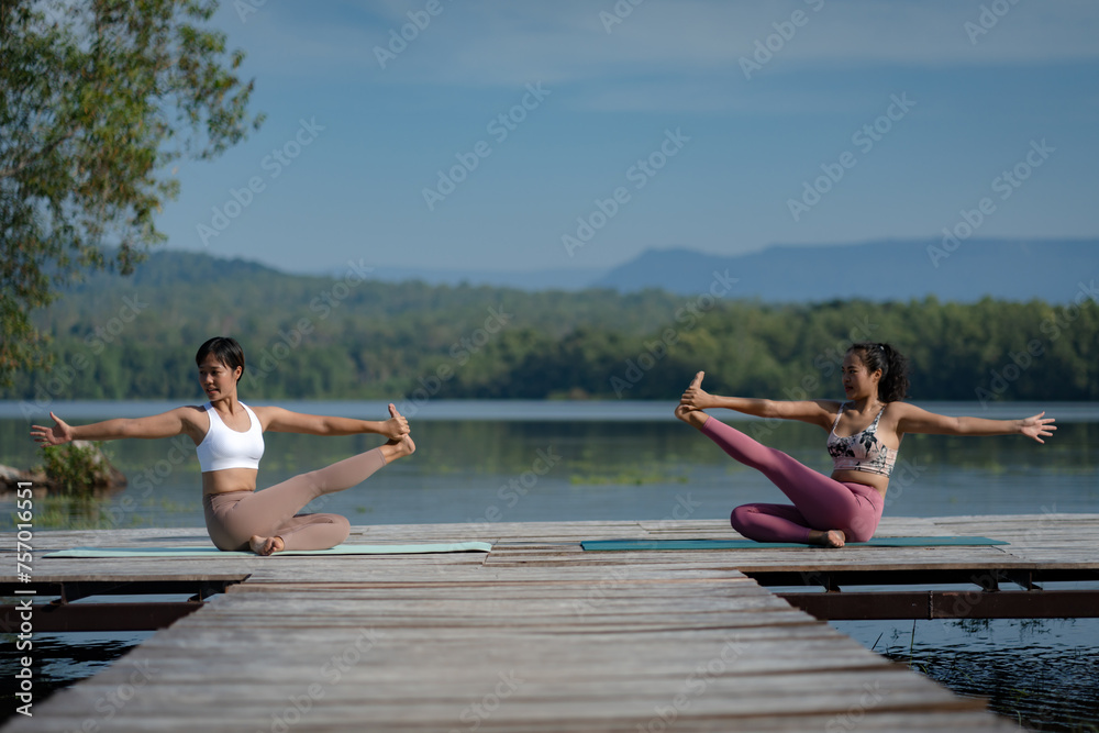 Beautiful attractive Asian woman practice fitness yoga pose on the pool above the Mountain peak in front of nature lake views, Feel so comfortable lifestyle and relax exercise in holiday morning