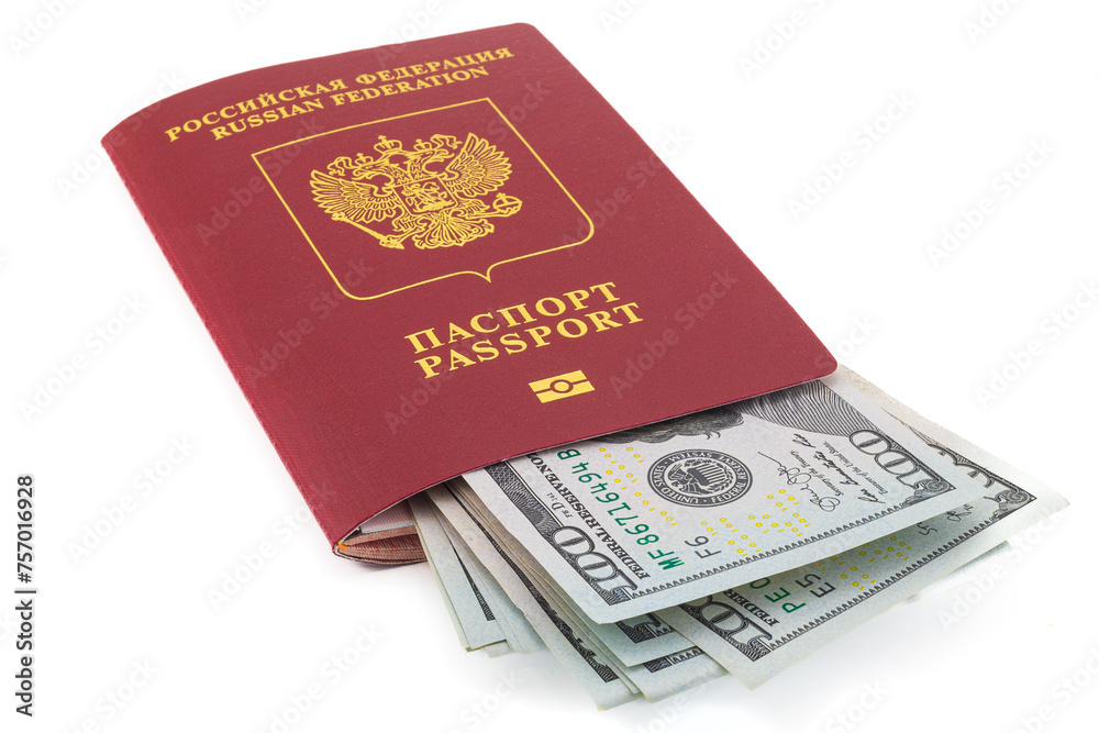 Pack of hundred US dollar bills inserted into a Russian passport isolated on white background. Concept travel on with cash due to international financial sanctions on Russian bank cards Pack of hundred US dollar bills inserted into a Russian passport isolated on white background. Concept travel on with cash due to international financial sanctions on Russian bank cards