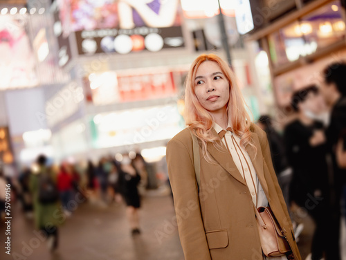 Asian woman friends shopping together at Shibuya district, Tokyo, Japan with crowd of people walking in the city. Attractive girl enjoy and fun outdoor lifestyle travel city in autumn holiday vacation
