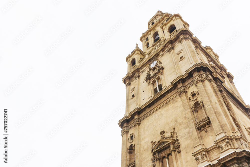 Murcia cathedral background. Rainy day white sky. Traveling around Spain. Cityscape spanish architecture. Cathedral de Santa Maria tower with clock.